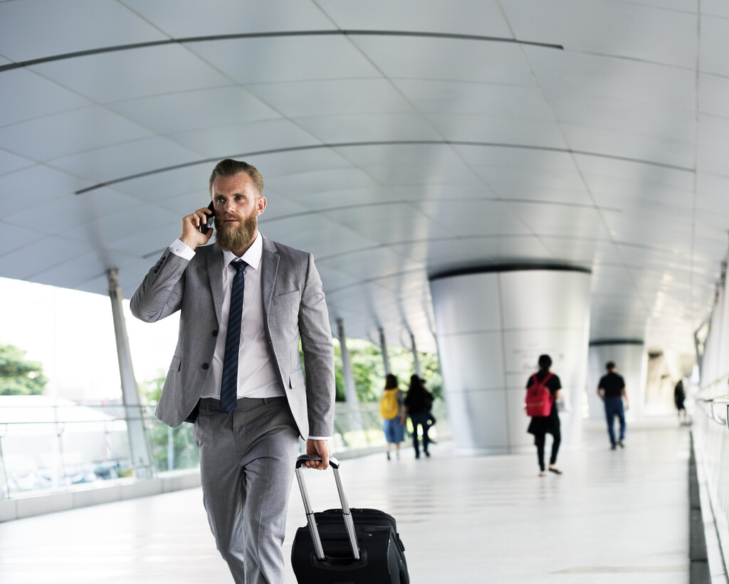 businessmen walk call phone luggage business trip - Airport Check-In Software 13 airport check-in software revenue management