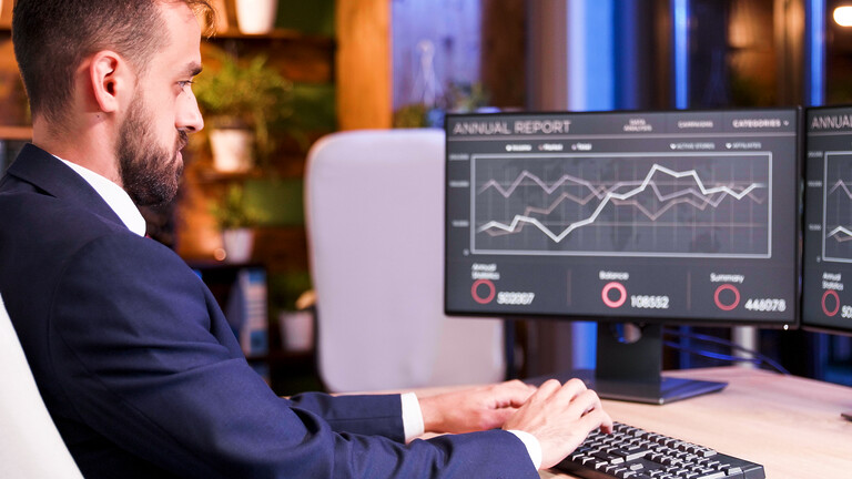 close up with businessman patching something keyboard graphics monitor - Insurance AI Development Services 17 Automated extraction of fund report data